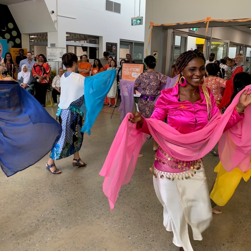 Palmerston Harmony Day event showcasing the beauty of cultural diversity through traditional dance performances by women in cultural dresses