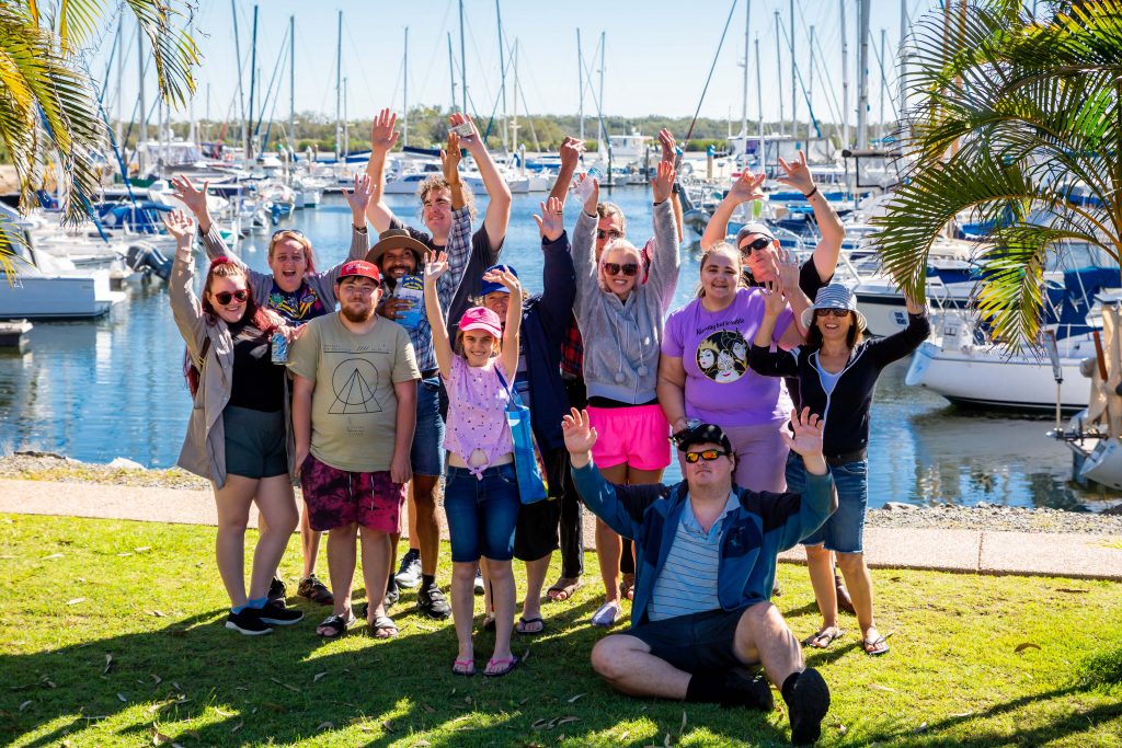 Group of happy people near a marina