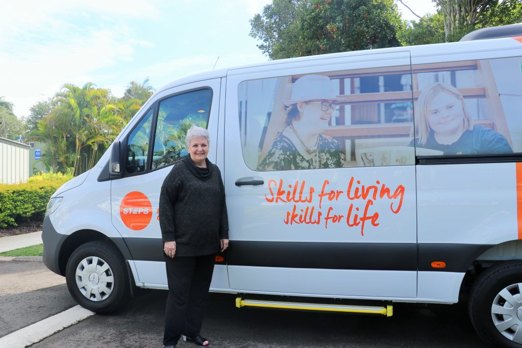 STEPS Director in front of bus